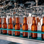 beer bottles filling on the conveyor belt in the brewery factory